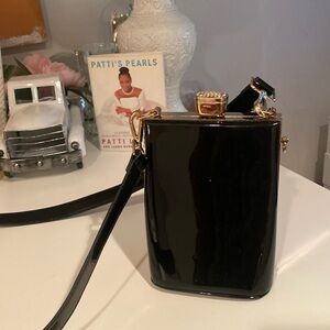 Shiny black shoulder bag with long strap. Excellent condition